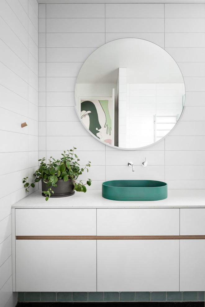 Example of a large trendy master white tile and porcelain tile concrete floor, black floor and single-sink bathroom design in Melbourne with flat-panel cabinets, white cabinets, a one-piece toilet, white walls, a vessel sink, quartz countertops, a hinged shower door, white countertops and a built-in vanity