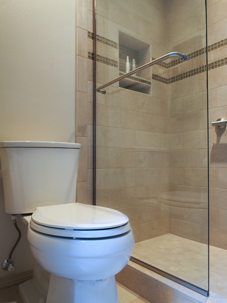 This is an example of a large traditional master bathroom in Seattle with a drop-in sink, raised-panel cabinets, white cabinets, engineered quartz benchtops, a drop-in tub, an alcove shower, a two-piece toilet, beige tile, porcelain tile, white walls, porcelain floors, beige floor, a sliding shower screen, a double vanity, multi-coloured benchtops, a built-in vanity and recessed.