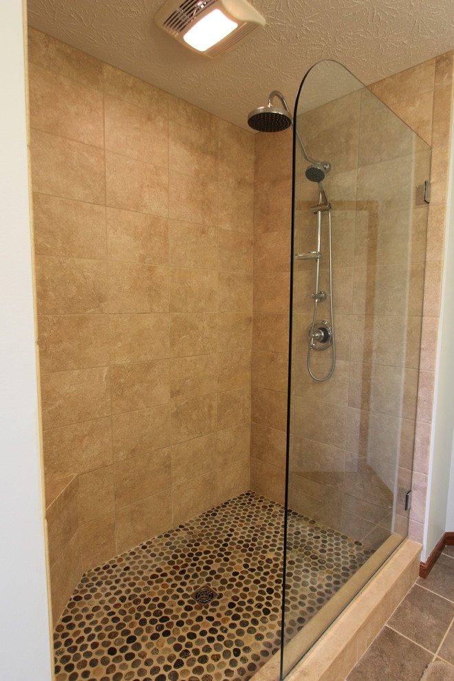 Photo of a small transitional master bathroom in Cleveland with an undermount sink, recessed-panel cabinets, medium wood cabinets, granite benchtops, a double shower, black tile, ceramic tile, beige walls and porcelain floors.