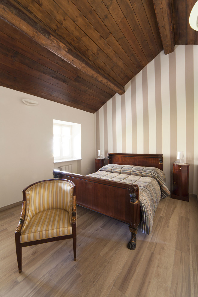 Traditional master bedroom in Milan with brown walls and porcelain floors.