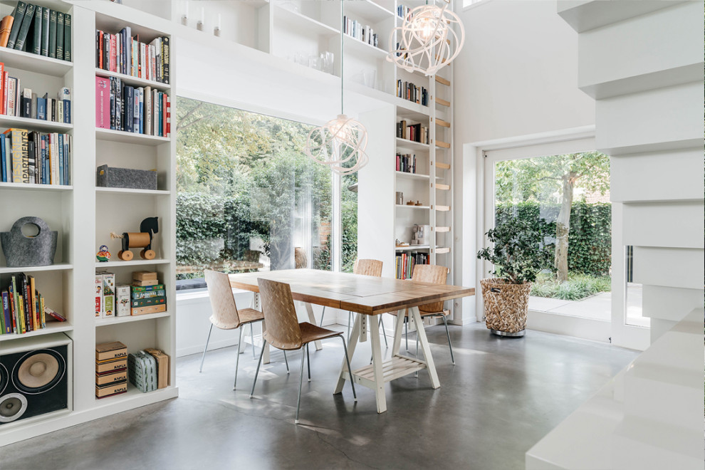 Inspiration for a contemporary dining room in Other with white walls, concrete floors and grey floor.