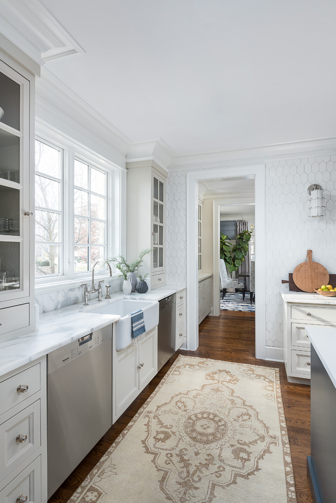Large transitional medium tone wood floor and brown floor kitchen photo in Chicago with a farmhouse sink, beaded inset cabinets, blue cabinets, marble countertops, white backsplash, ceramic backsplash, stainless steel appliances, two islands and yellow countertops