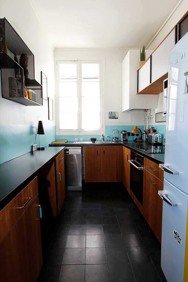 This is an example of a midcentury u-shaped separate kitchen in Paris with a single-bowl sink, medium wood cabinets, laminate benchtops, blue splashback, stainless steel appliances and terra-cotta floors.