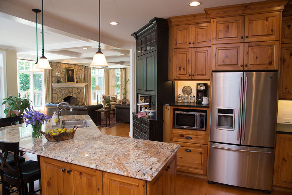 Inspiration for a large rustic u-shaped light wood floor open concept kitchen remodel in Chicago with an undermount sink, raised-panel cabinets, distressed cabinets, granite countertops, white backsplash, subway tile backsplash, stainless steel appliances and an island