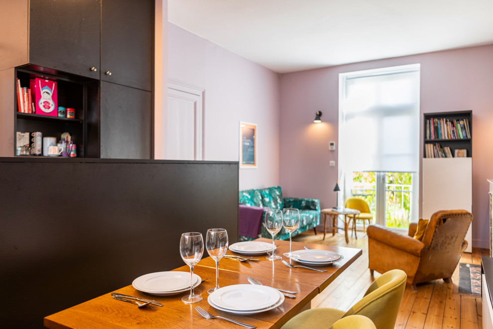 Inspiration for a mid-sized traditional open plan dining in Other with pink walls and light hardwood floors.