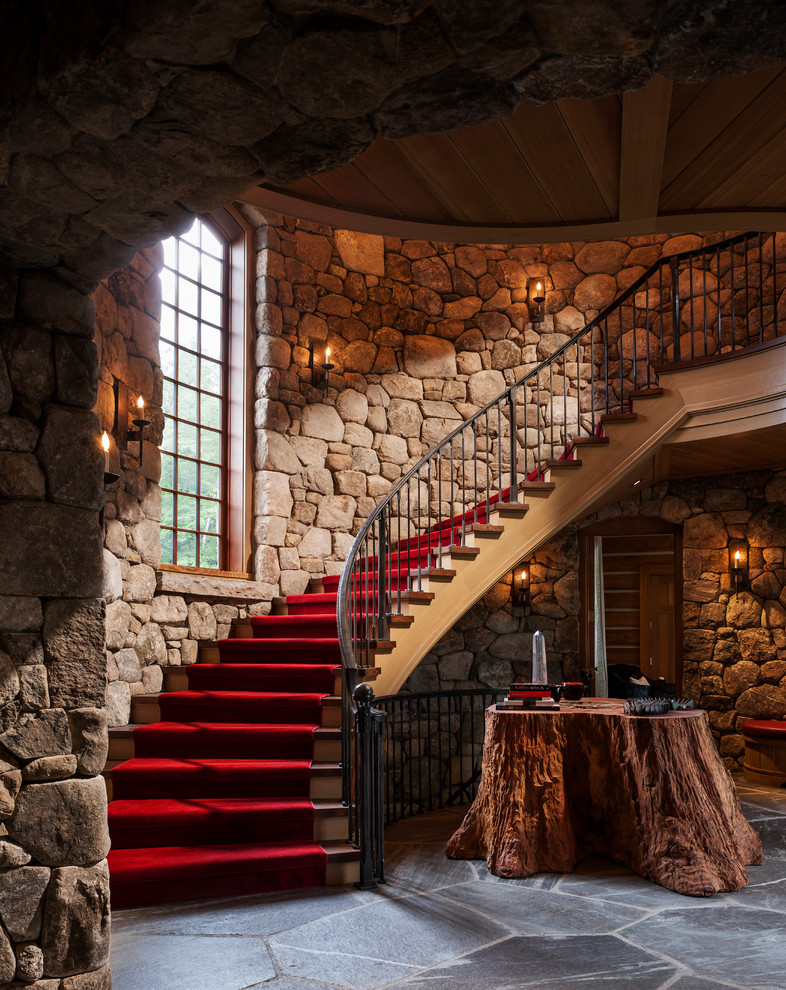 Inspiration for a rustic wooden curved staircase remodel in New York with wooden risers