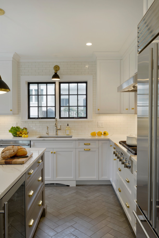 Example of a small transitional u-shaped porcelain tile and gray floor enclosed kitchen design in New York with an undermount sink, recessed-panel cabinets, white cabinets, quartz countertops, white backsplash, ceramic backsplash, stainless steel appliances, an island and white countertops