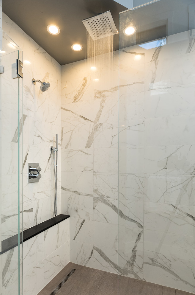 Modern master bathroom in San Francisco with flat-panel cabinets, white cabinets, a freestanding tub, a curbless shower, stone slab, white walls, porcelain floors, a vessel sink, beige floor and a hinged shower door.