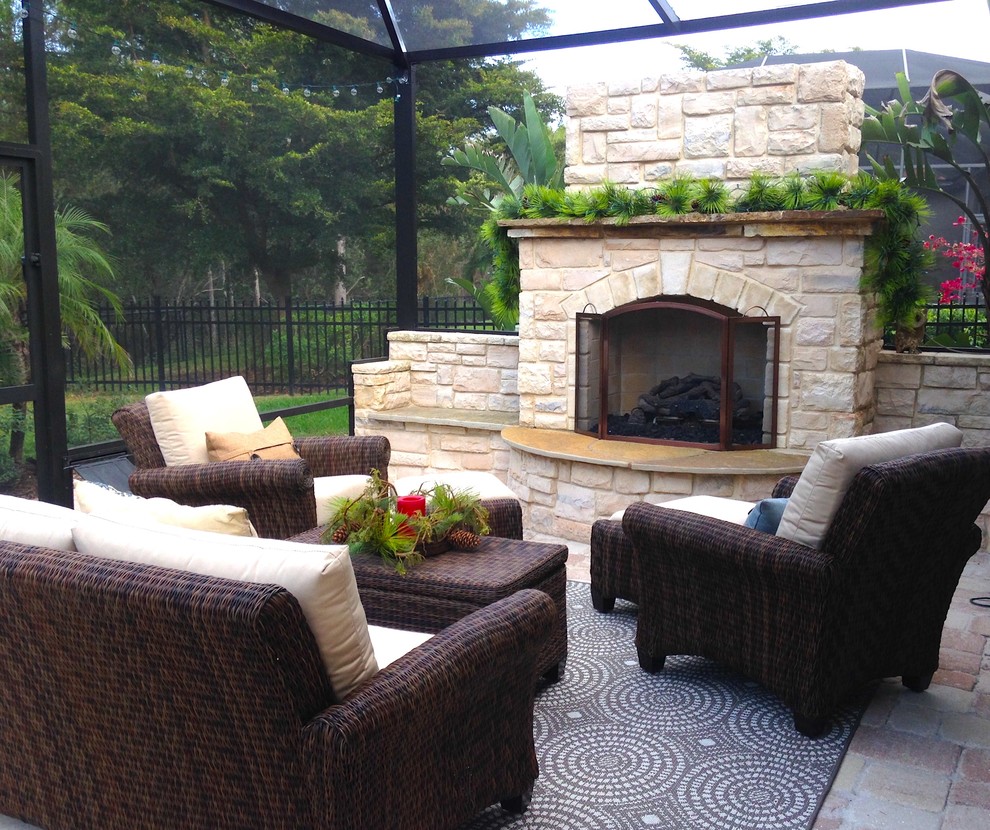 Mid-sized traditional backyard patio in Miami with a fire feature and brick pavers.