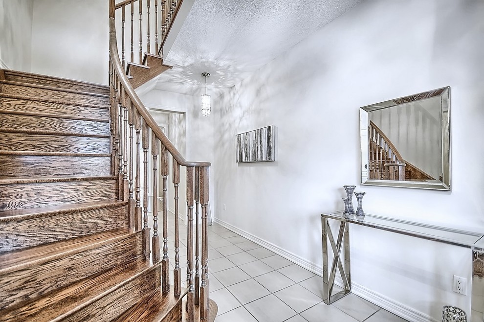 Foyer - mid-sized transitional ceramic tile and beige floor foyer idea in Toronto with beige walls and a white front door