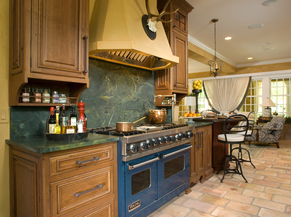 Country kitchen in Indianapolis with green splashback, stone slab splashback and coloured appliances.