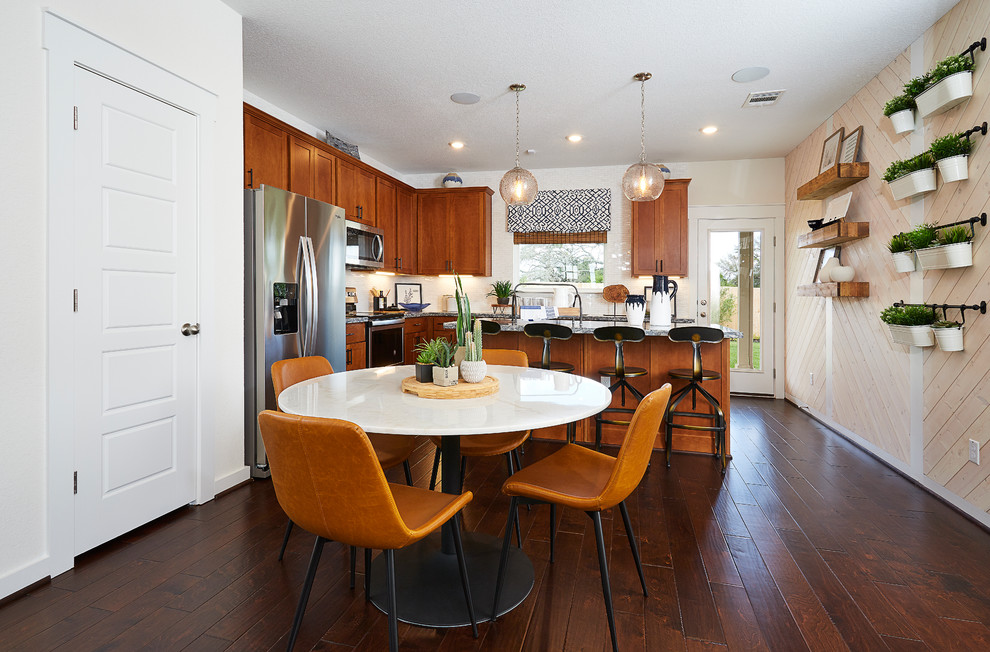 Photo of a mid-sized contemporary kitchen/dining combo in Austin with white walls, dark hardwood floors and brown floor.
