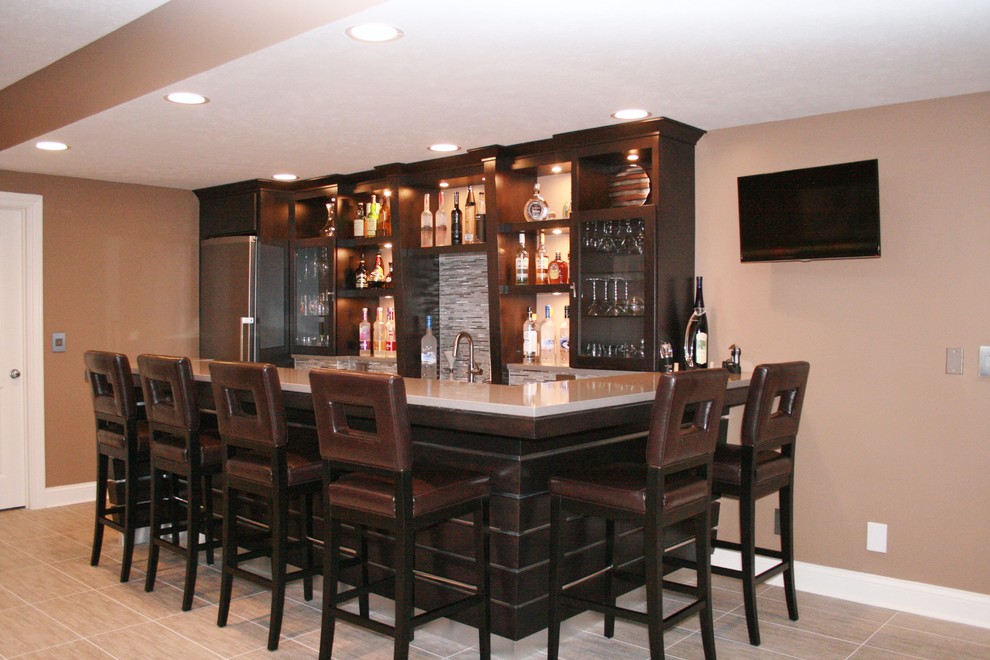Photo of a mid-sized contemporary l-shaped seated home bar in Chicago with an undermount sink, glass-front cabinets, dark wood cabinets, quartzite benchtops, grey splashback, glass tile splashback and ceramic floors.