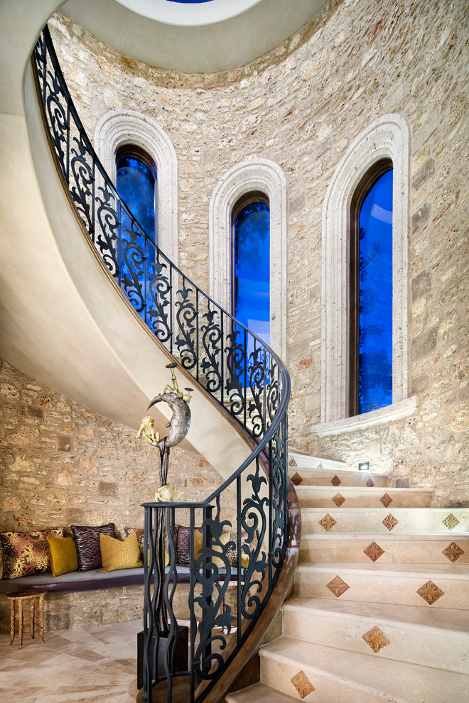 Inspiration for a huge mediterranean spiral staircase remodel in Houston with tile risers