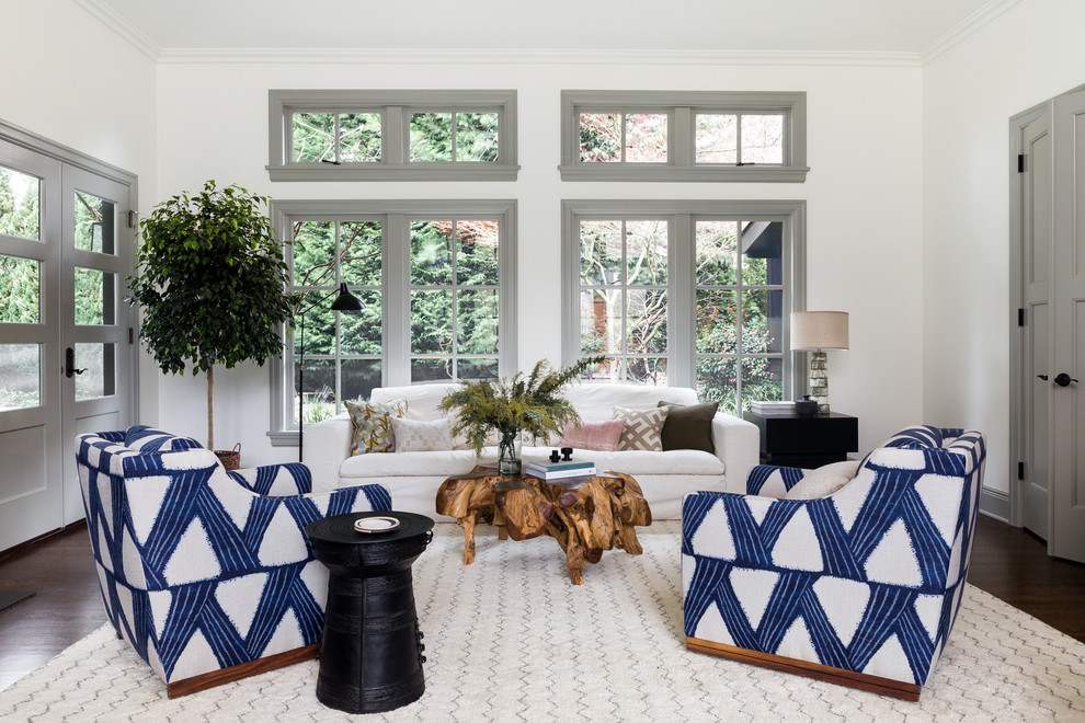Photo of a beach style family room in Seattle with white walls, dark hardwood floors and brown floor.
