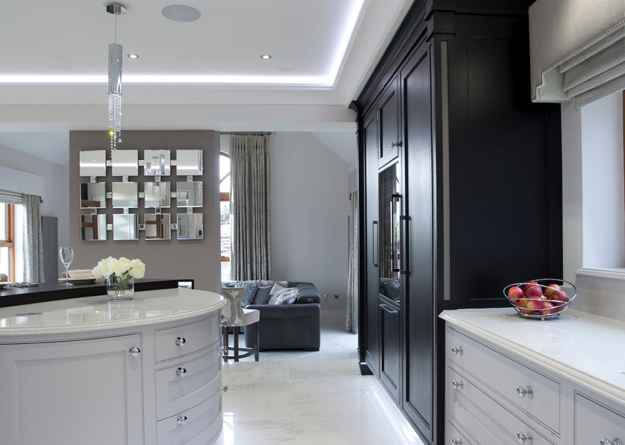 This is an example of a mid-sized contemporary l-shaped open plan kitchen in Belfast with an integrated sink, beaded inset cabinets, grey cabinets, quartzite benchtops, white splashback, stone slab splashback, stainless steel appliances, marble floors and with island.