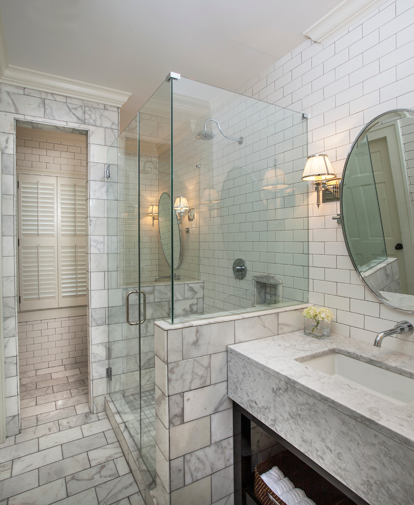 This is an example of a traditional bathroom in New Orleans with an undermount sink, open cabinets, a corner shower, white tile, subway tile, white walls and grey benchtops.