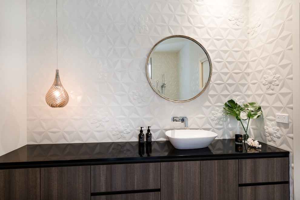 Mid-sized contemporary powder room in Melbourne with furniture-like cabinets, dark wood cabinets, a one-piece toilet, white tile, ceramic tile, white walls, a vessel sink and granite benchtops.