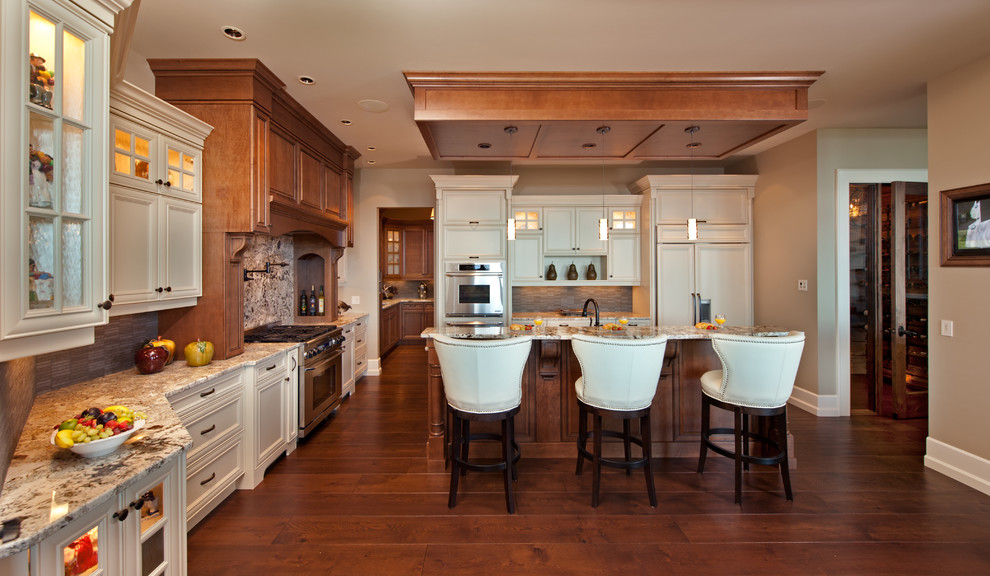 Traditional kitchen in Vancouver with recessed-panel cabinets, beige cabinets and panelled appliances.