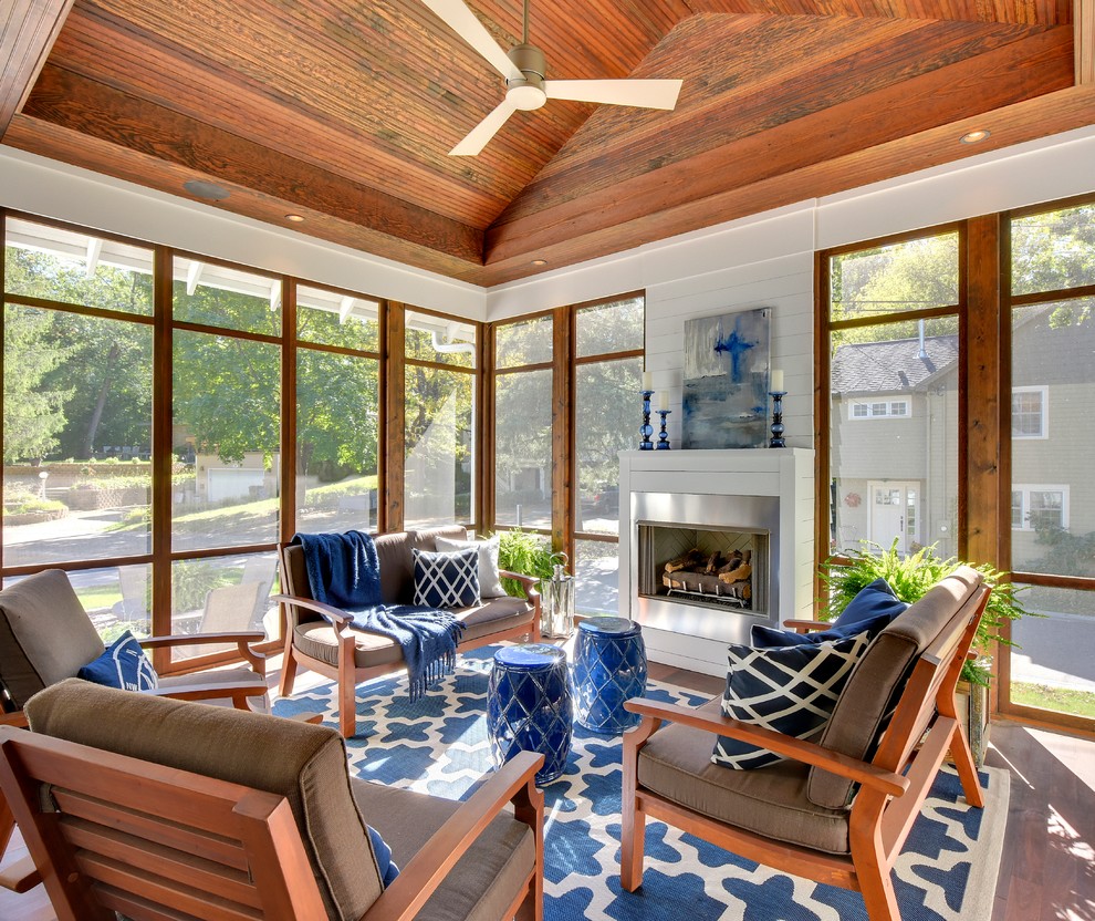 Beach style sunroom in Minneapolis with dark hardwood floors, a metal fireplace surround, a standard ceiling and a standard fireplace.