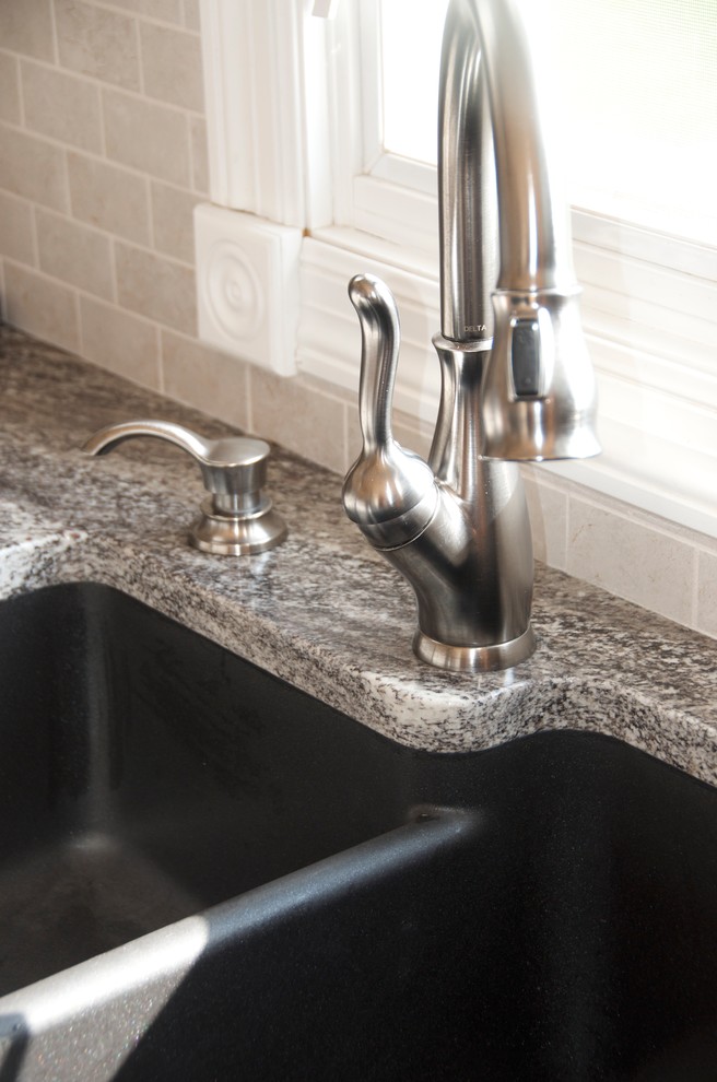 Kitchen - mid-sized transitional u-shaped medium tone wood floor kitchen idea with an undermount sink, flat-panel cabinets, white cabinets, granite countertops, gray backsplash, subway tile backsplash, white appliances and an island