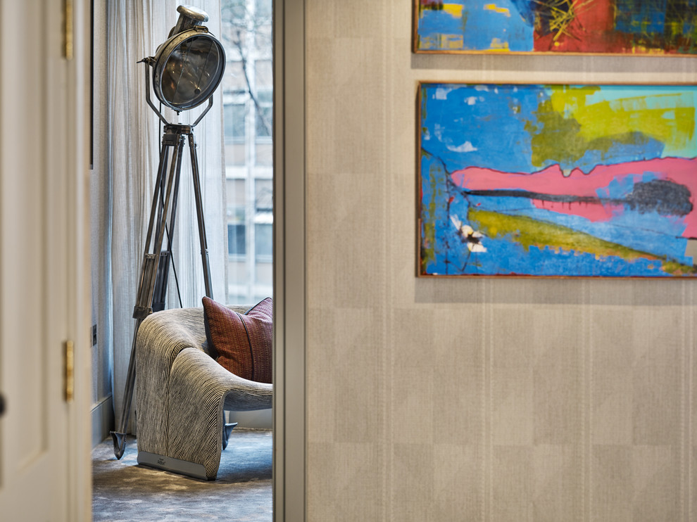 This is an example of a large modern hallway in London with beige walls, carpet and grey floor.