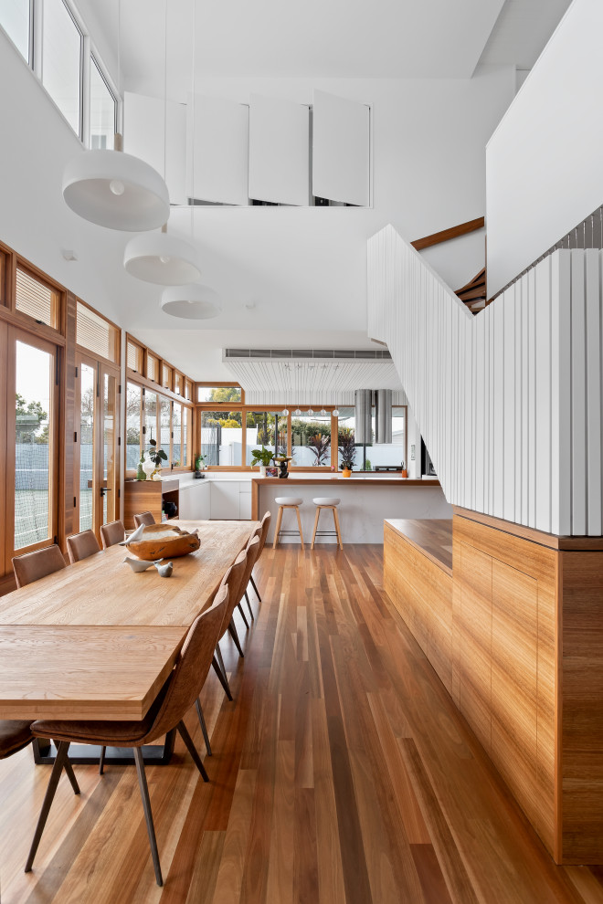 This is an example of a beach style dining room in Brisbane.