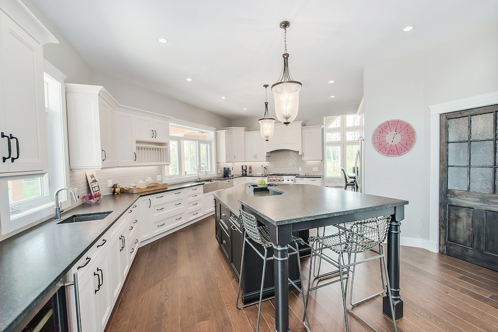 Example of a transitional kitchen design in Calgary