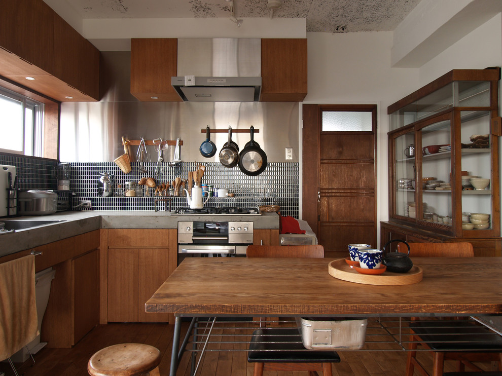 Inspiration for an asian kitchen in Tokyo with flat-panel cabinets, medium wood cabinets and medium hardwood floors.