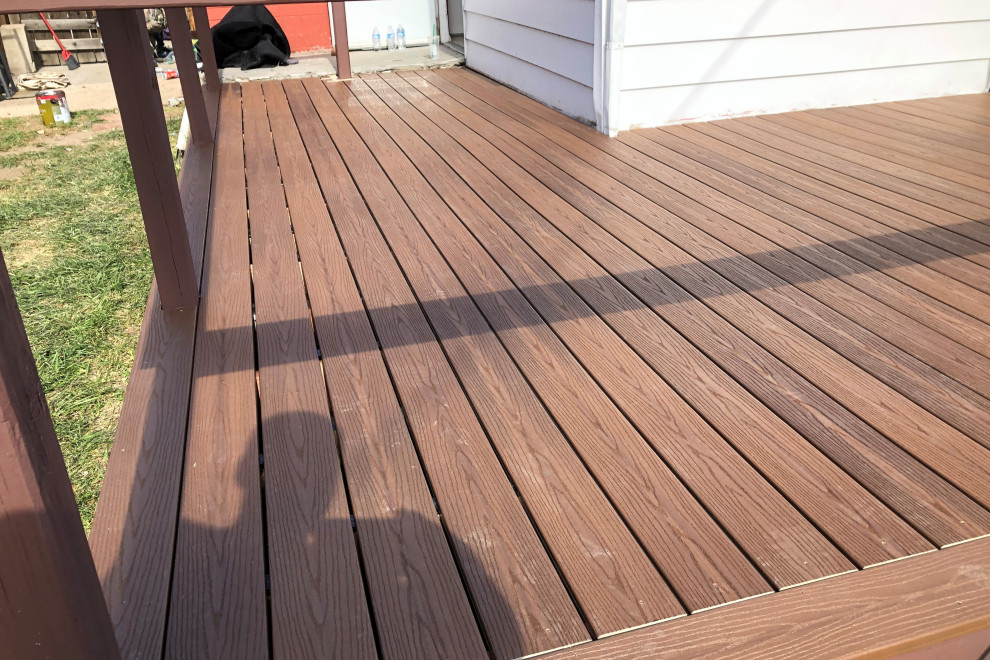 Deck - mid-sized backyard ground level wood railing deck idea in Denver with no cover