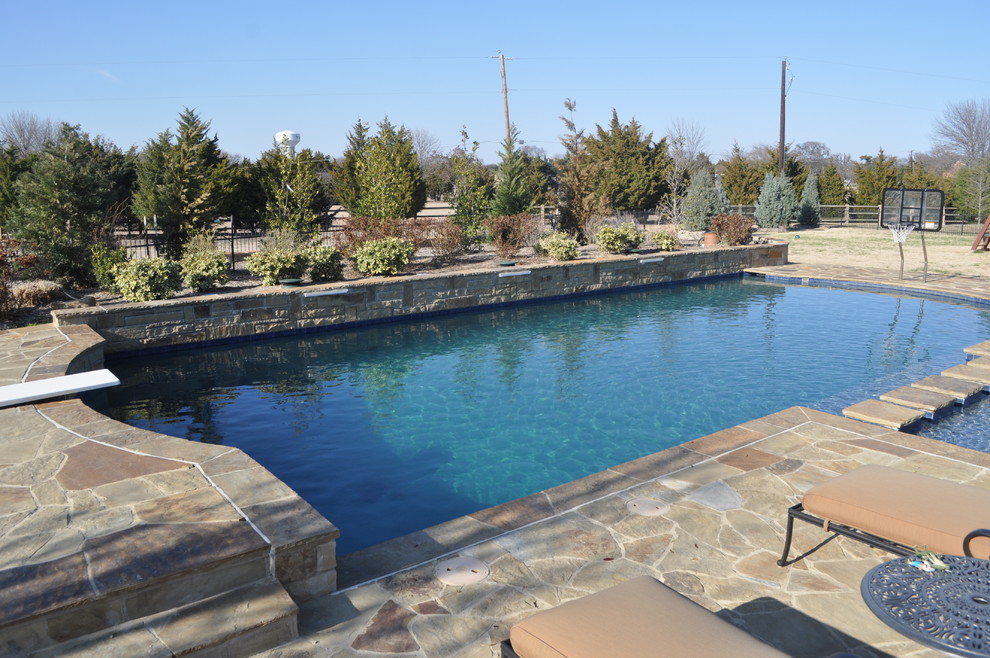 Large traditional backyard rectangular natural pool in Dallas with natural stone pavers.