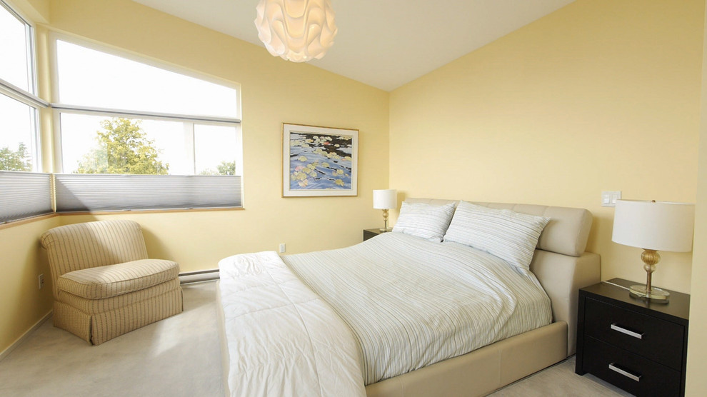 Mid-sized modern master bedroom in Vancouver with yellow walls, no fireplace and carpet.