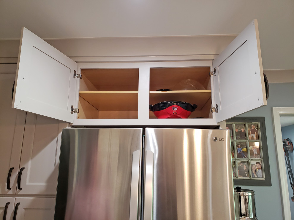 Inspiration for a mid-sized transitional l-shaped vinyl floor and brown floor eat-in kitchen remodel in Nashville with a farmhouse sink, recessed-panel cabinets, gray cabinets, quartz countertops, gray backsplash, ceramic backsplash, stainless steel appliances, an island and brown countertops