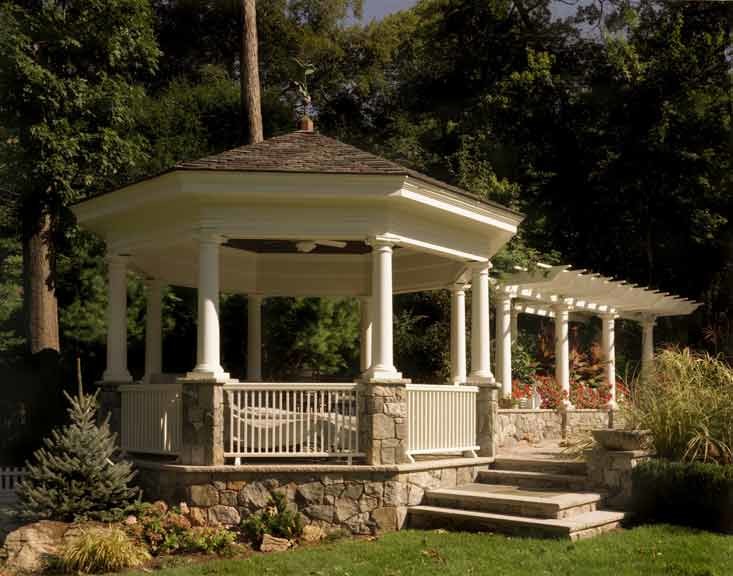 Photo of a mid-sized arts and crafts patio in New York with natural stone pavers and a gazebo/cabana.