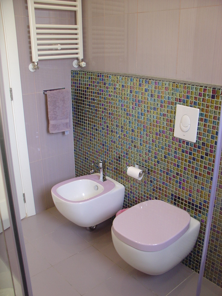 Photo of a modern bathroom in Other with a bidet and mosaic tile.