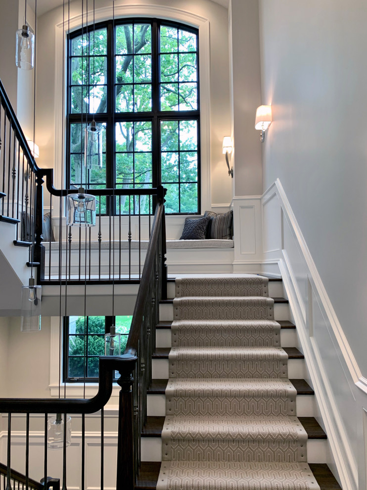 Photo of an expansive traditional wood staircase in Chicago with wood risers and wood railing.