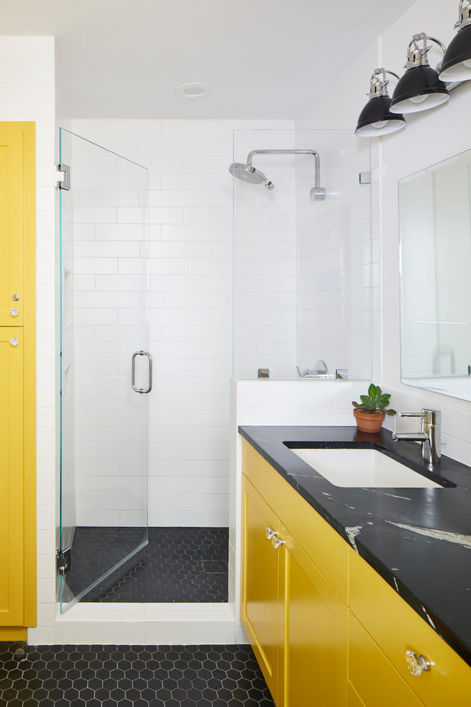 Inspiration for a small eclectic wet room bathroom in Austin with shaker cabinets, a one-piece toilet, white tile, ceramic tile, white walls, ceramic floors, an undermount sink, soapstone benchtops, white floor, black benchtops, yellow cabinets, with a sauna and a hinged shower door.