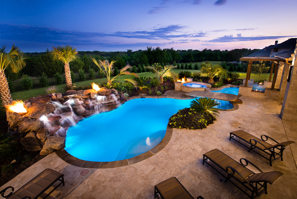 Inspiration for a large world-inspired back custom shaped swimming pool in Dallas.