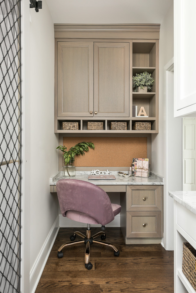 Mid-sized transitional medium tone wood floor and brown floor enclosed kitchen photo in Chicago with a farmhouse sink, recessed-panel cabinets, gray cabinets, quartzite countertops, gray backsplash, stone slab backsplash, paneled appliances, an island and gray countertops