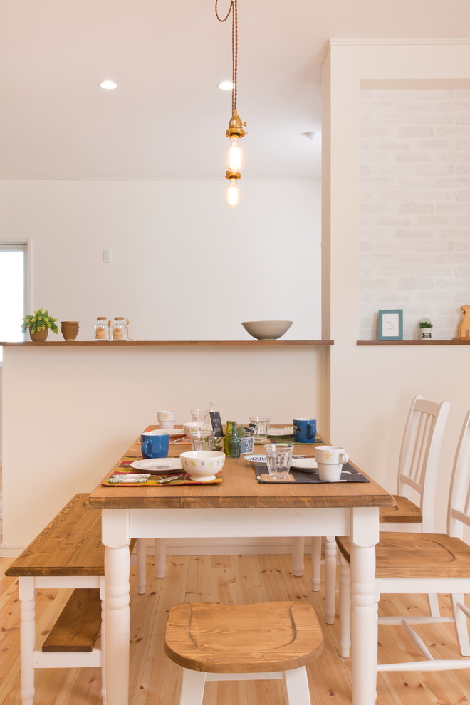 Design ideas for a scandinavian open plan dining in Other with white walls and light hardwood floors.