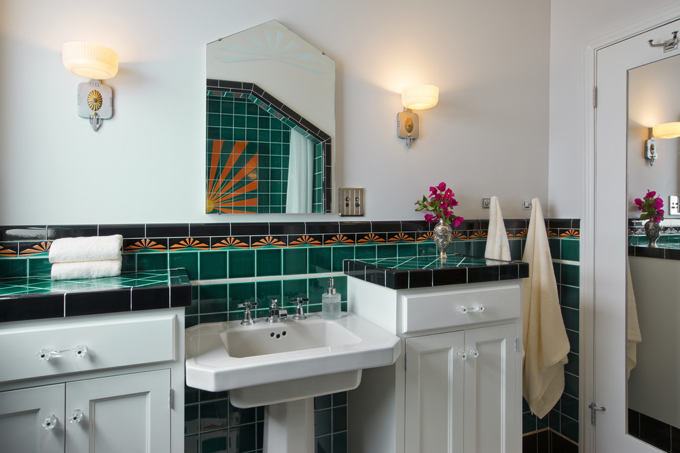 This is an example of a small modern 3/4 bathroom in Los Angeles with recessed-panel cabinets, an alcove shower, a one-piece toilet, green tile, white walls, ceramic floors, a pedestal sink, tile benchtops, white floor, a shower curtain and a drop-in tub.