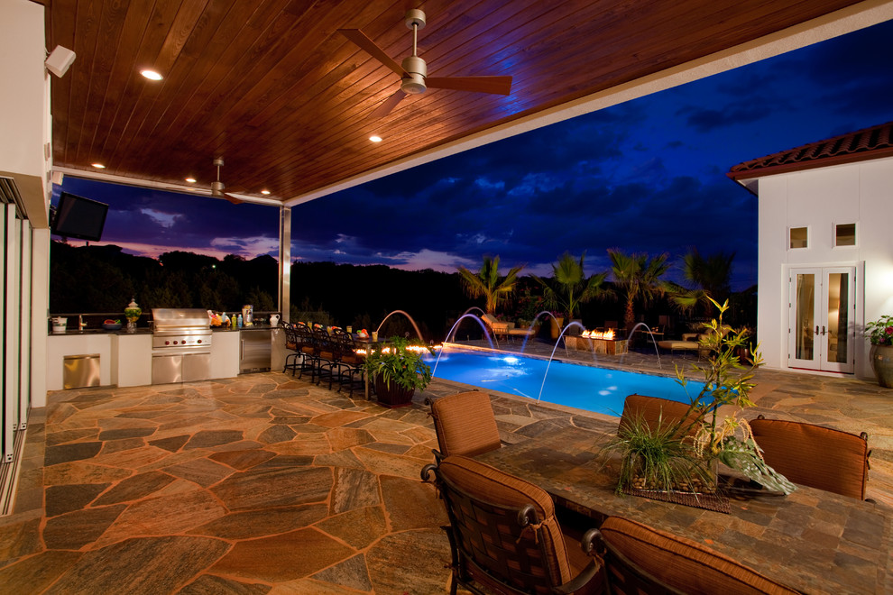 Inspiration for a mid-sized rustic backyard stone and rectangular infinity pool remodel in Austin