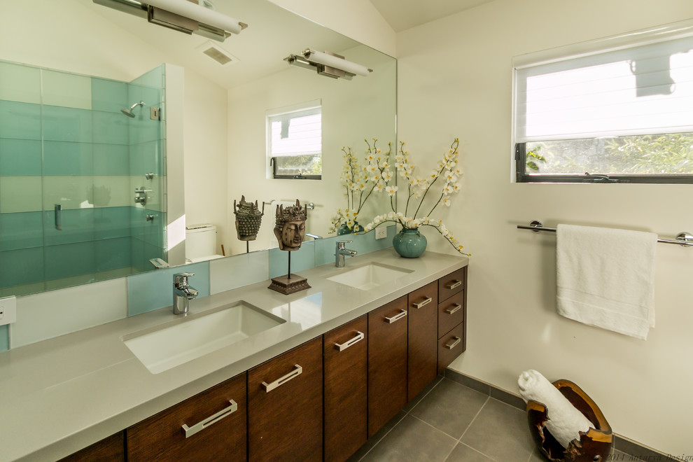 Small contemporary 3/4 bathroom in San Francisco with flat-panel cabinets, white cabinets, a corner shower, a two-piece toilet, blue tile, glass tile, white walls, concrete floors, an undermount sink, engineered quartz benchtops, grey floor, a hinged shower door and grey benchtops.