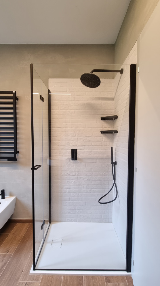Inspiration for a small urban cloakroom in Milan with flat-panel cabinets, grey cabinets, a wall mounted toilet, beige tiles, beige walls, porcelain flooring, a vessel sink, wooden worktops, brown floors, beige worktops, a floating vanity unit, a drop ceiling and brick walls.