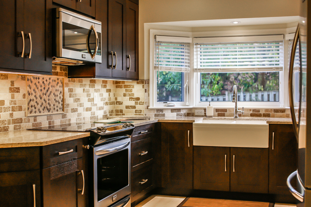 Inspiration for a mid-sized transitional u-shaped porcelain tile enclosed kitchen remodel in Toronto with a farmhouse sink, shaker cabinets, dark wood cabinets, quartz countertops, beige backsplash, stone tile backsplash, stainless steel appliances and no island