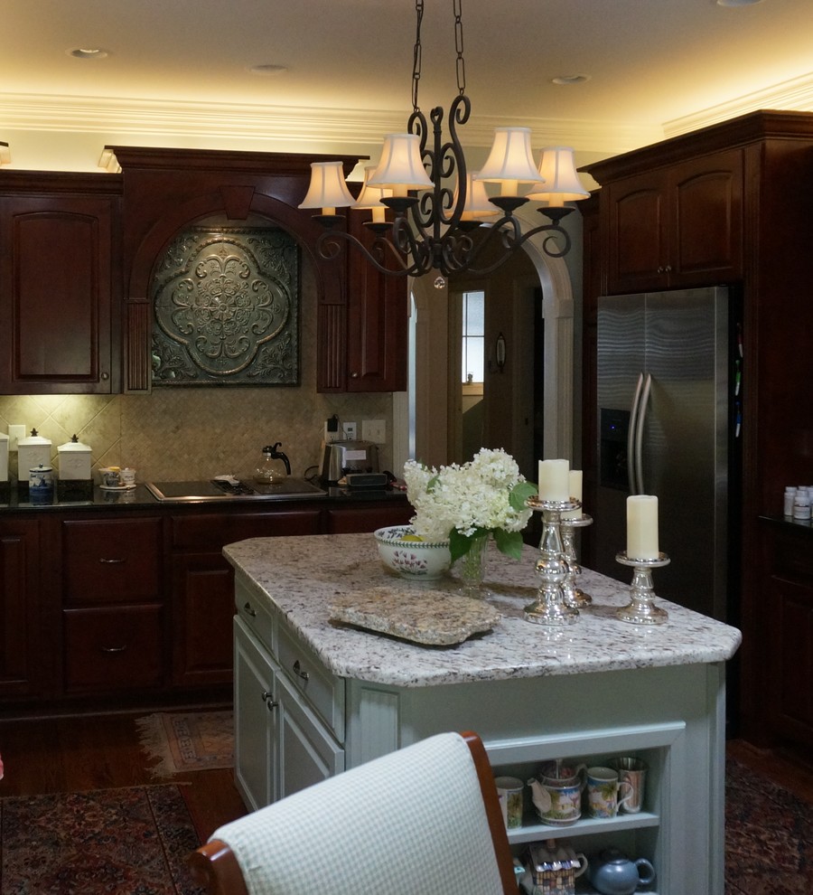 Inspiration for a large transitional u-shaped eat-in kitchen remodel with raised-panel cabinets, granite countertops and an island