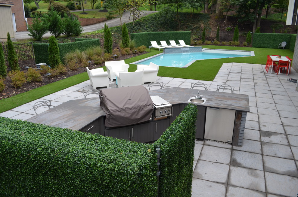 Inspiration for a mid-sized modern backyard concrete paver and custom-shaped lap pool fountain remodel