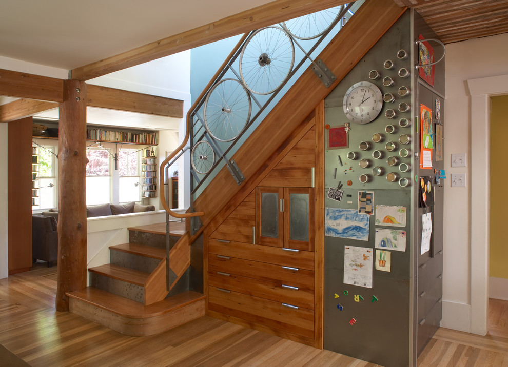 Photo of a mid-sized eclectic wood l-shaped staircase in San Francisco with wood risers and metal railing.