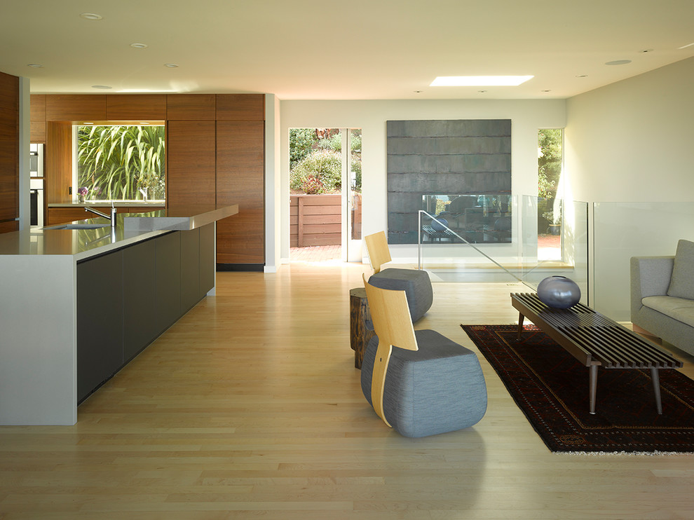Photo of a large contemporary open concept living room in San Francisco with light hardwood floors, beige floor, grey walls and no fireplace.