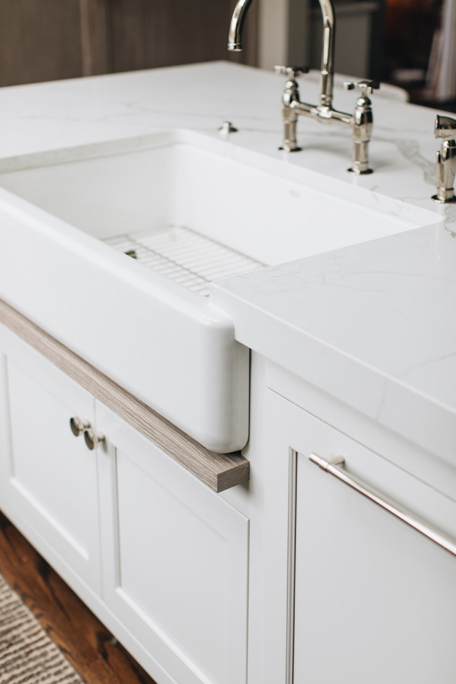 Inspiration for a mid-sized transitional dark wood floor and brown floor eat-in kitchen remodel in Chicago with a farmhouse sink, beaded inset cabinets, white cabinets, quartz countertops, paneled appliances, an island and white countertops